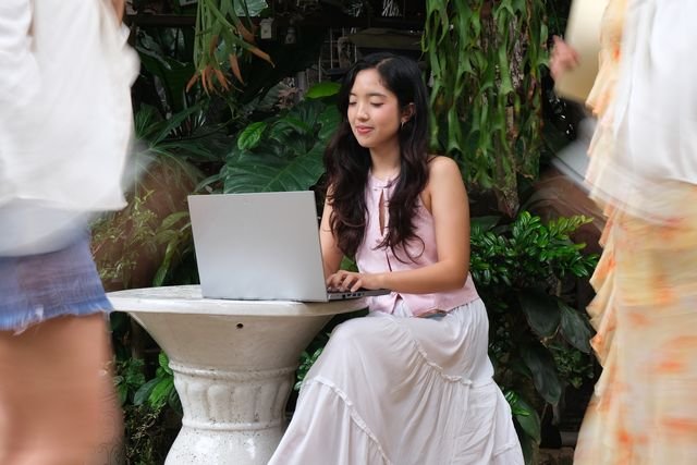 A team member working on a laptop in the garden