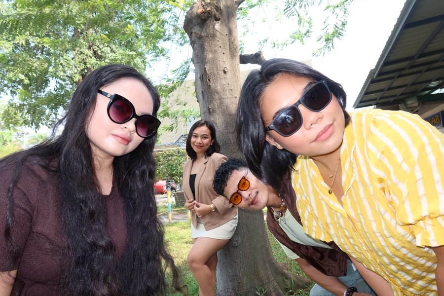 Two team members in sunglasses leaning into the camera